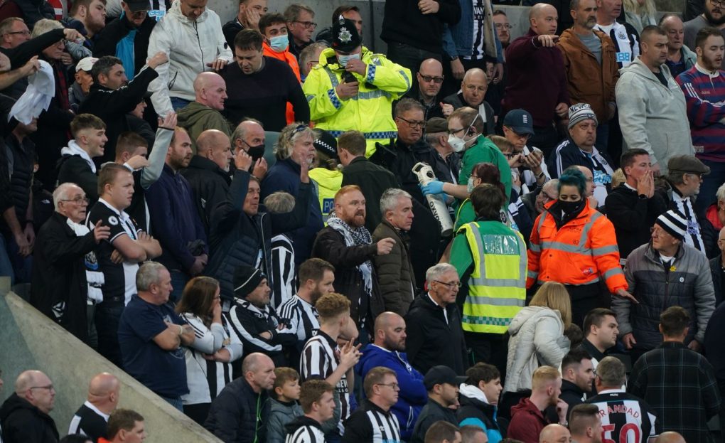 PA - Medical teams assist a fan who suffered a suspected cardiac arrest in the stands during Newcastle's game against Tottenham